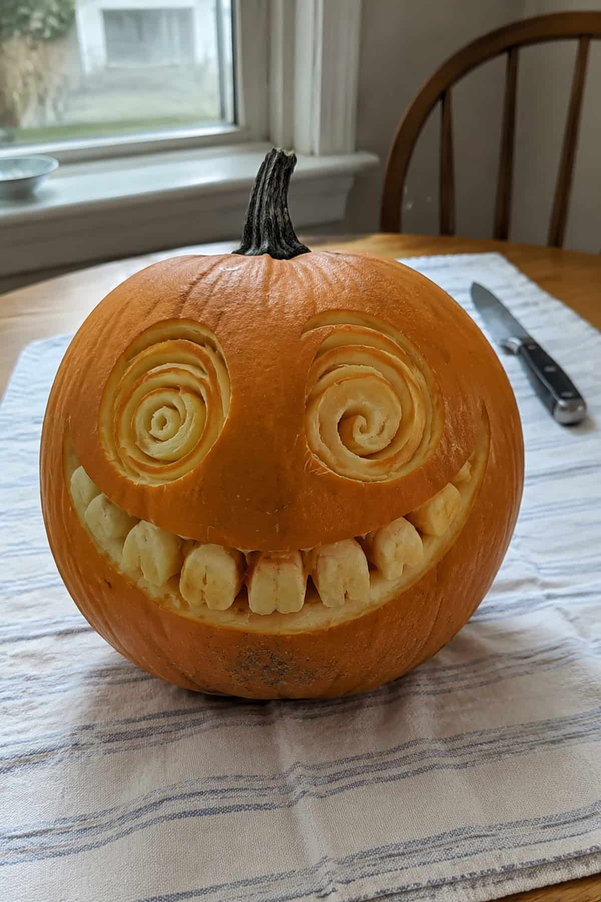 Wide Grin Pumpkin With Spiral Eyes