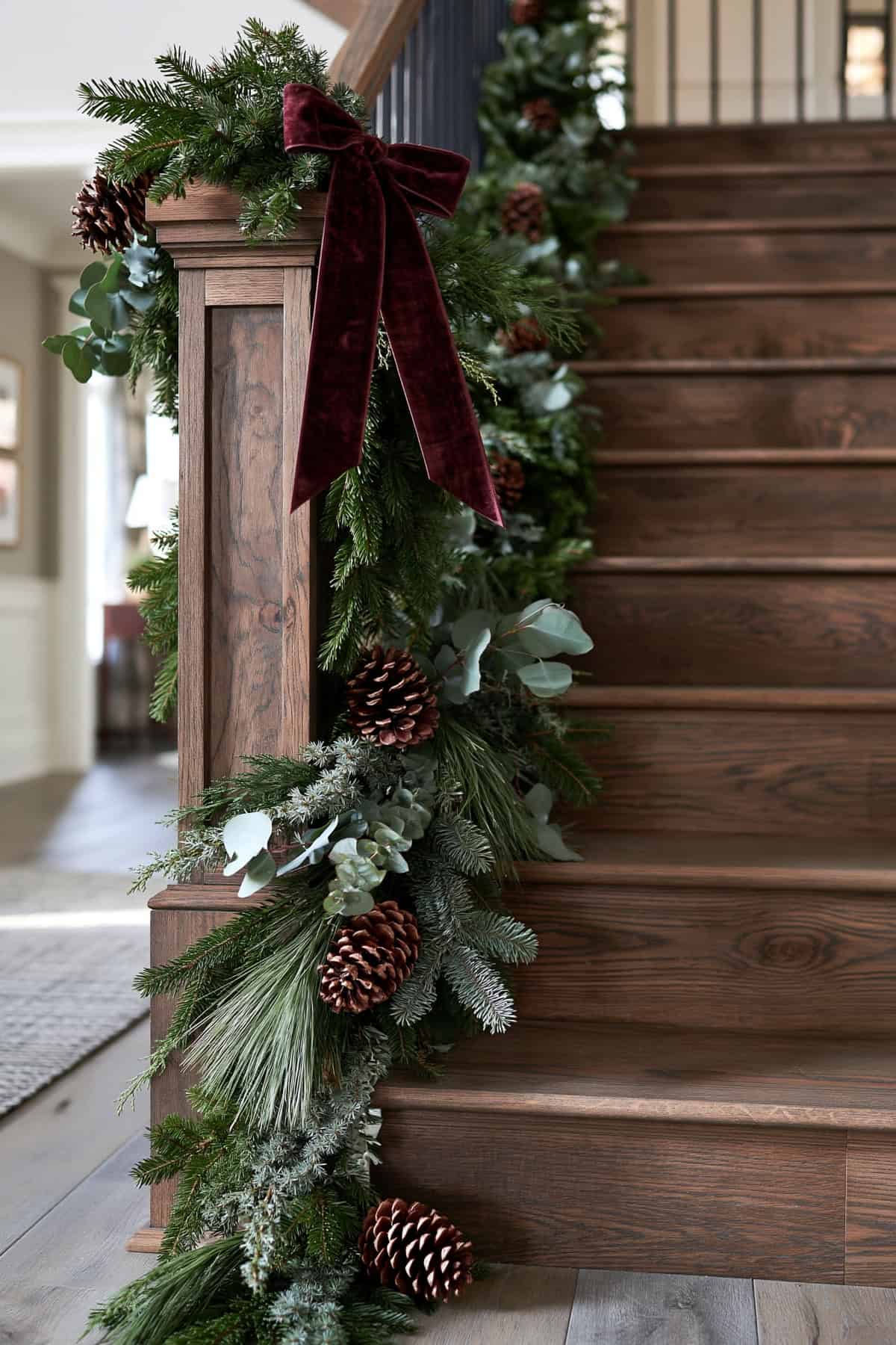Cascading Evergreen Garland Down A Stair Newel Post