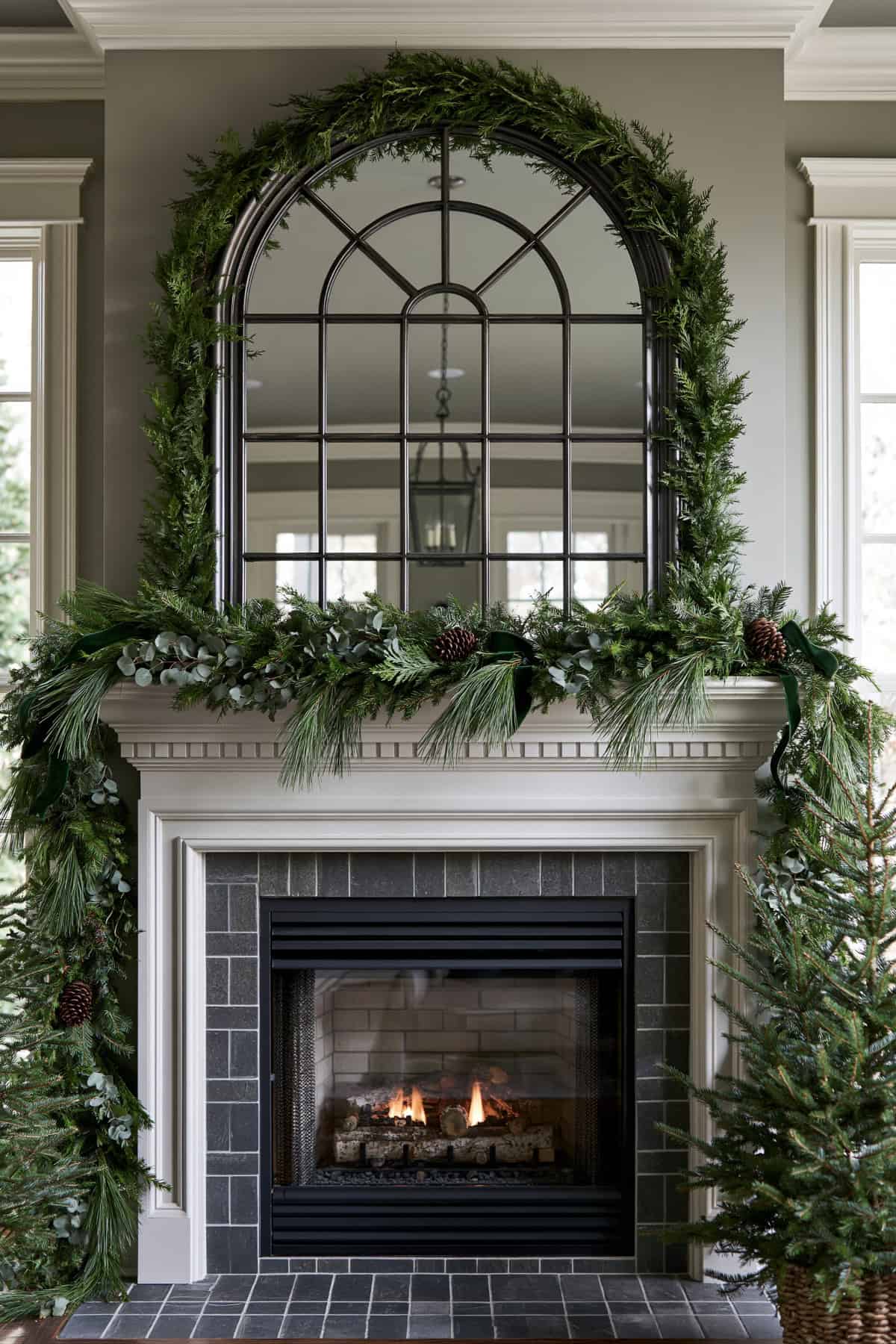 Greenery Garland Framing A Large Arched Mirror