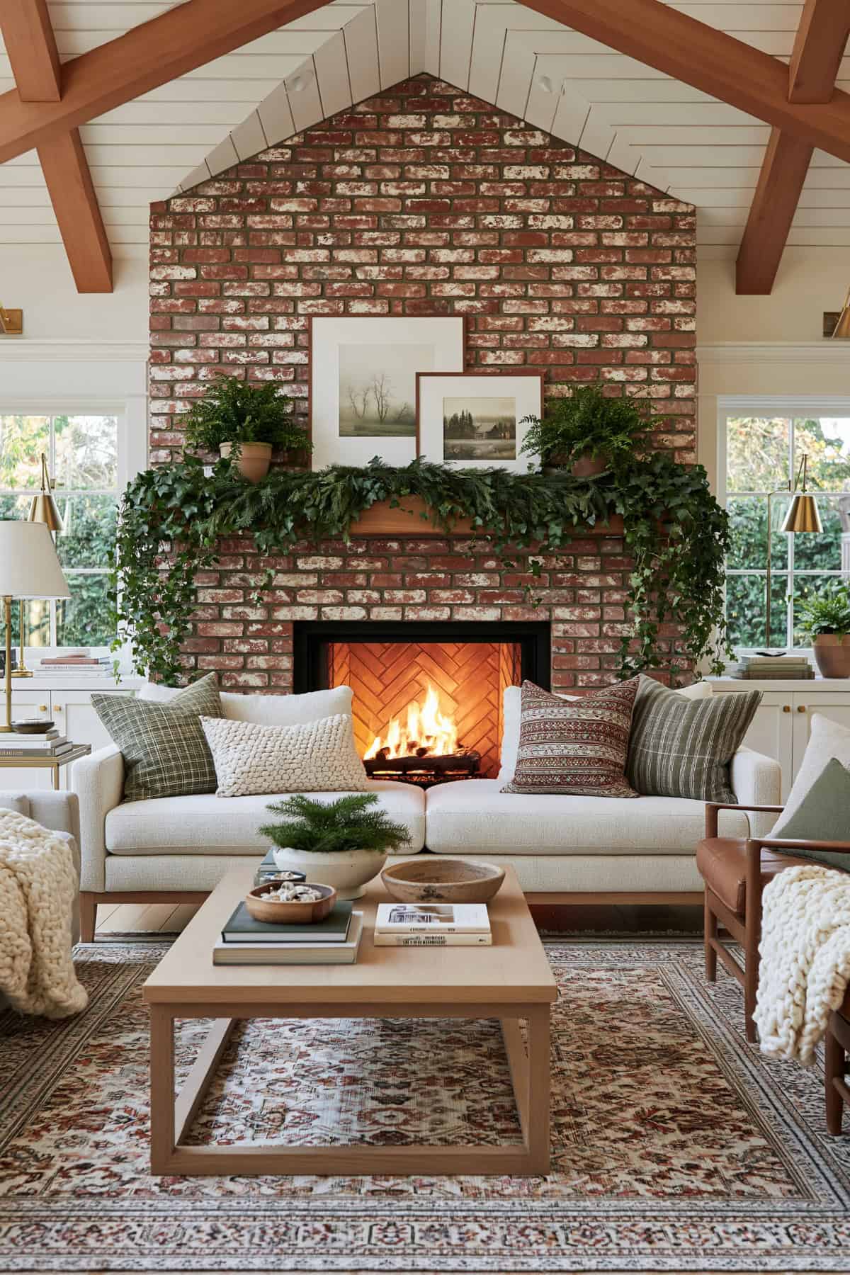 Hanging Ivy And Cedar Mantel Over A Brick Fireplace